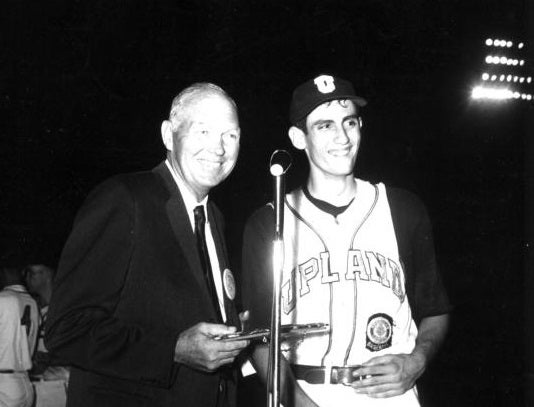Future Hall of Fame pitcher Rollie Fingers (right) accepts the American Legion's Player of the Year Award from Hall of Famer Bill Dickey in 1964. 