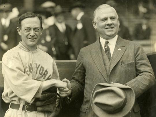 New York Yankees manager Miller Huggins (left) and New York Giants manager John McGraw shake hands during the 1923 World Series.