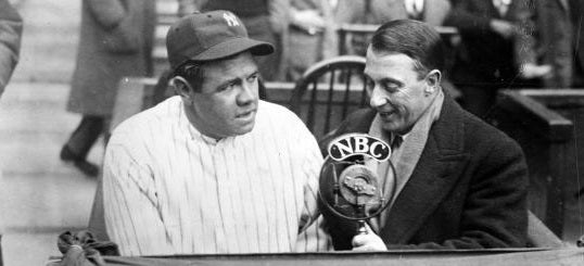 Babe Ruth and a reporter at a microphone