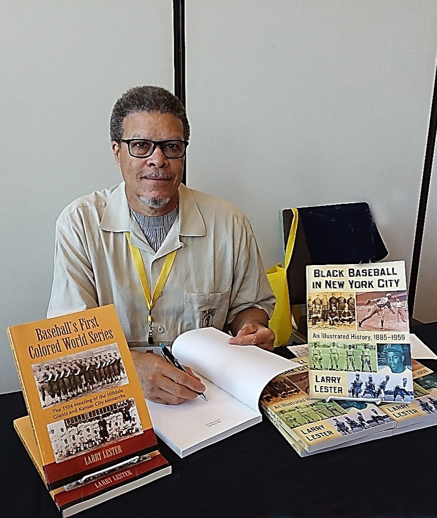 Larry Lester signing his book.
