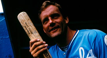 George Brett in dugout holding bat