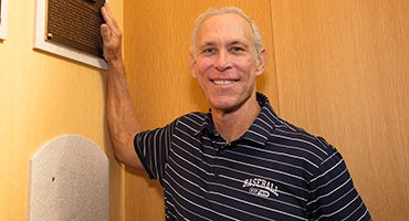 Alan Trammell stands with his Hall of Fame plaque