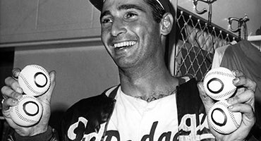 Sandy Koufax holds no-hitter baseballs