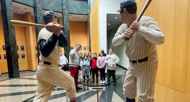 Hall of Fame educator shows students statues in Plaque Gallery