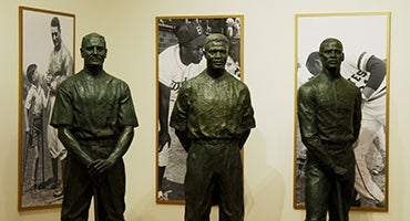 Lou Gehrig, Jackie Robinson and Roberto Clemente statues in Hall of Fame