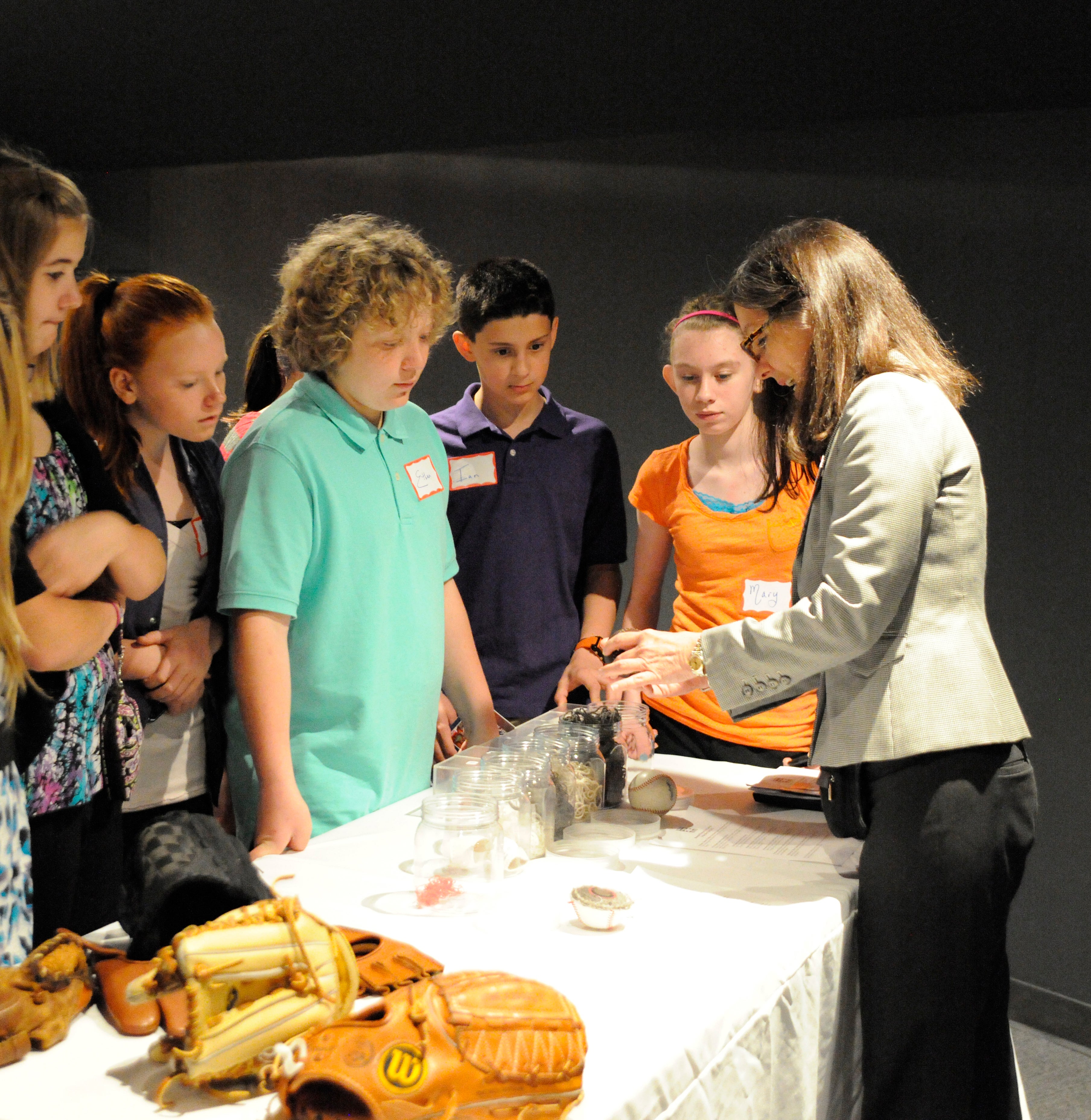 Children participating in a education history cart.