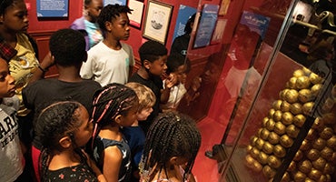 School group looks at artifacts