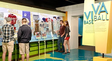 Museum visitors in ¡Viva Baseball! exhibit