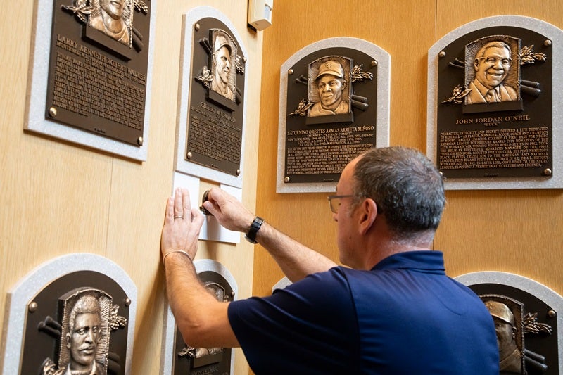 Military Service medallion being installed below a HOF plaque