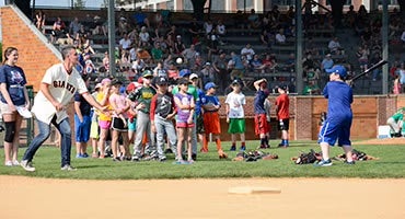 Youth players participate in hitting drill