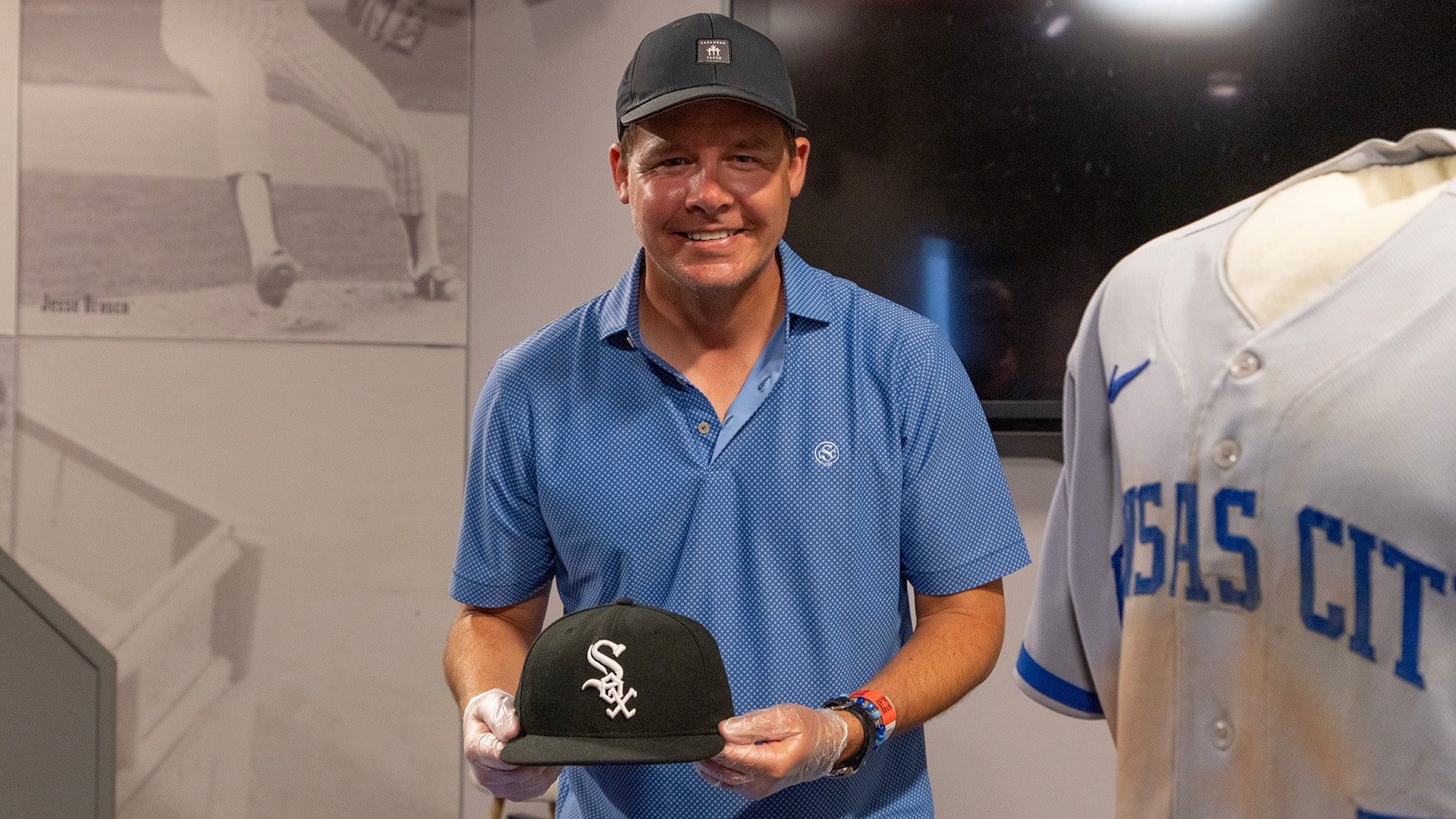 Chris Getz holds White Sox cap