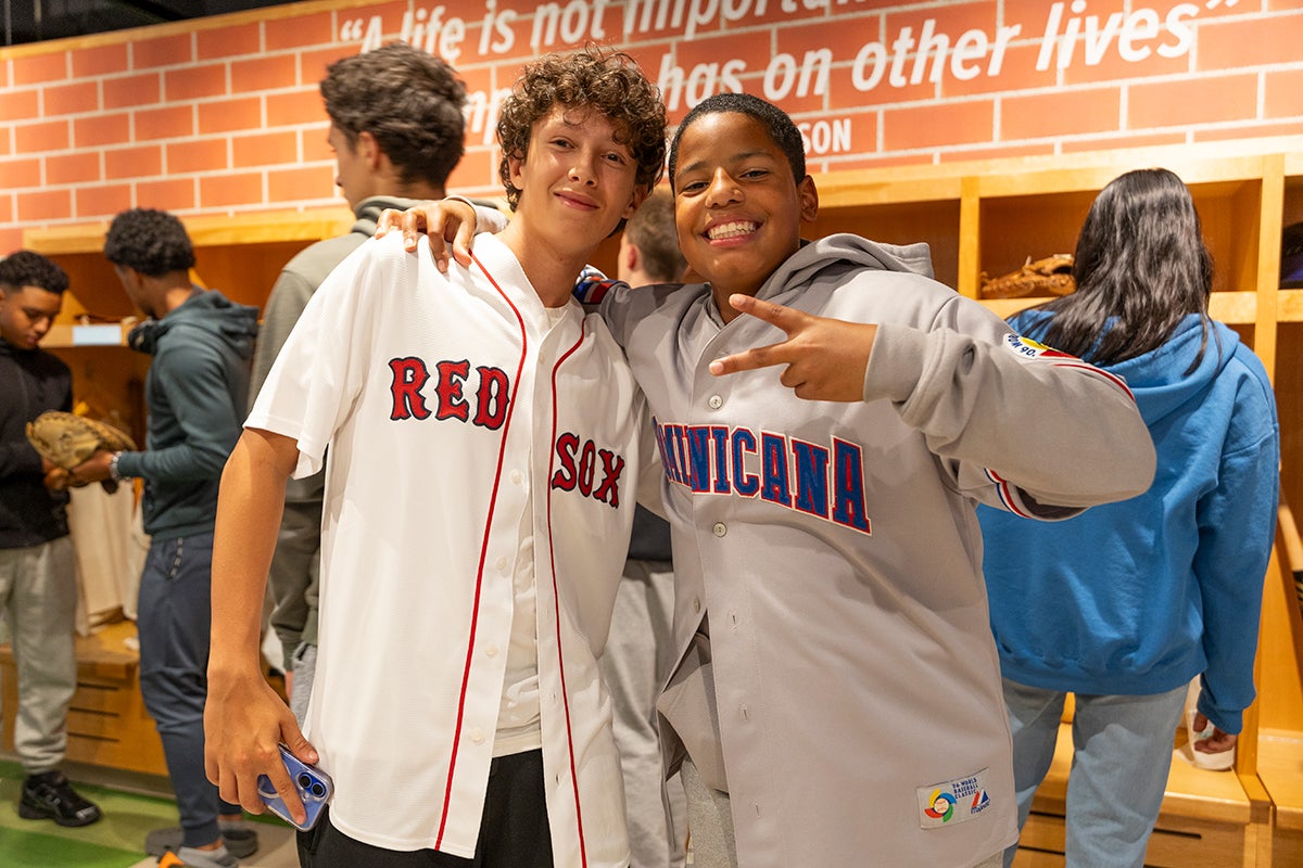Students pose for photo wearing Red Sox and Dominican Republic jerseys