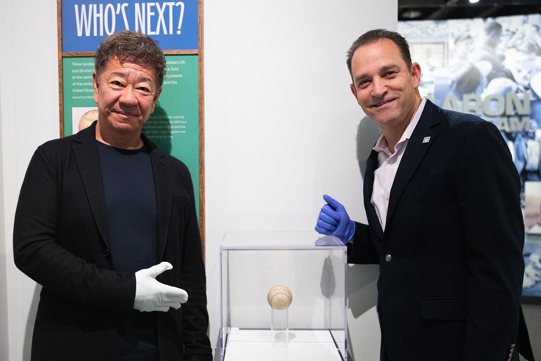 Hideki Tomita and Hall of Fame President Josh Rawitch pose with Dream Baseball signed by Babe Ruth, Sadaharu Oh and Shohei Ohtani