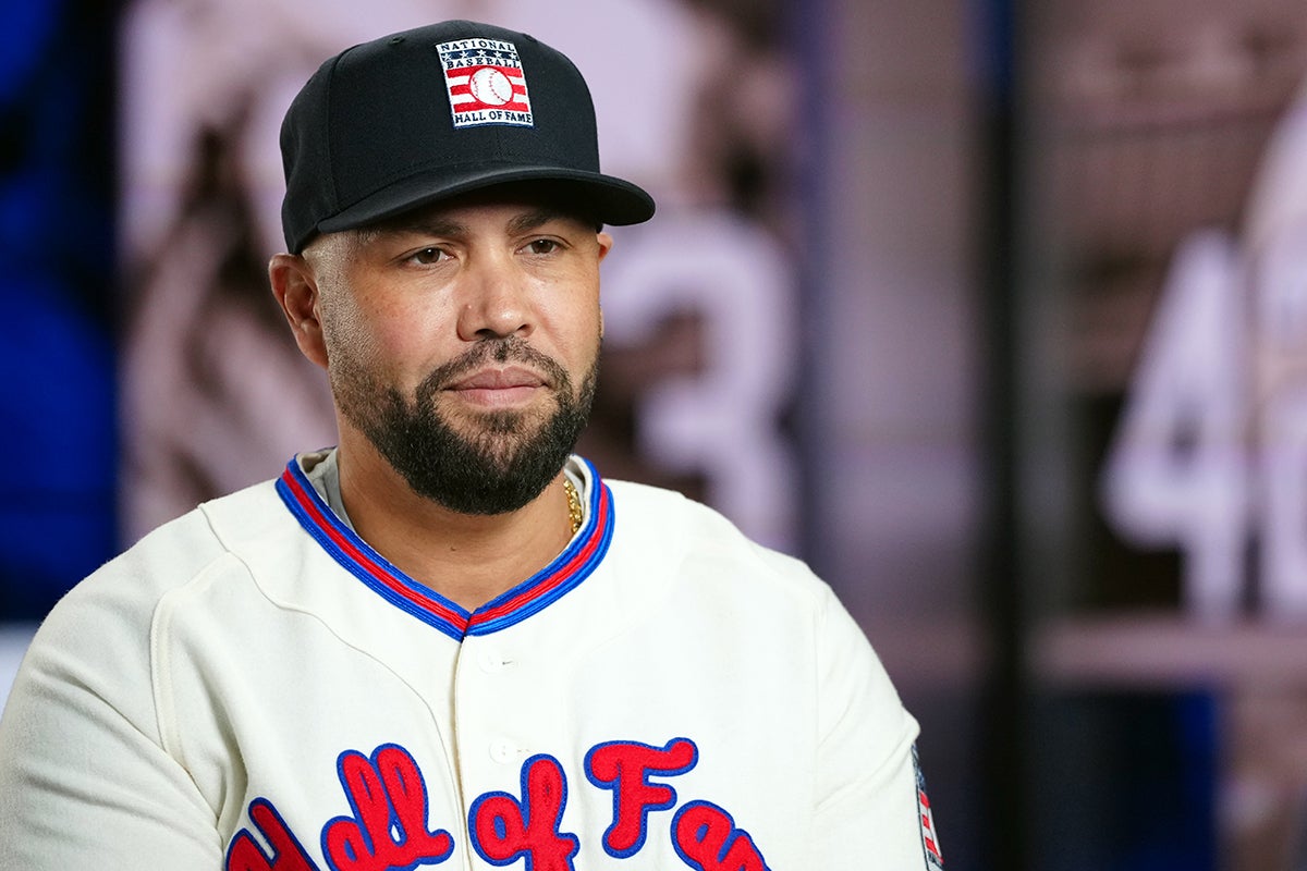 Carlos Beltrán wearing Hall of Fame cap and jersey
