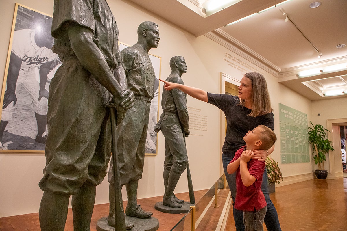 Woman and child looking at Character and Courage statues