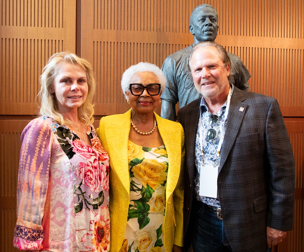 Jane Crotty, Billye Suber Aaron and Bob Crotty in front of the Museum's Hank Aaron statue