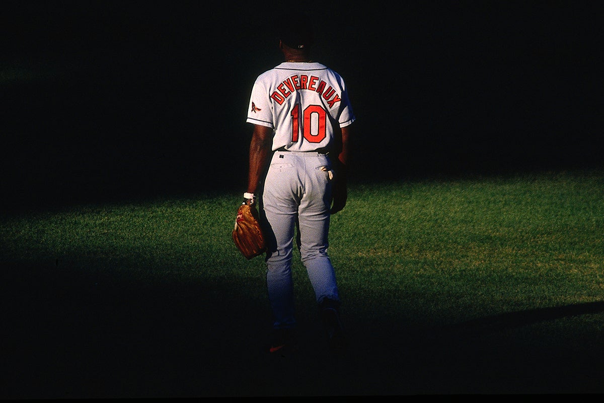 Mike Devereaux standing in shadow-cast outfield