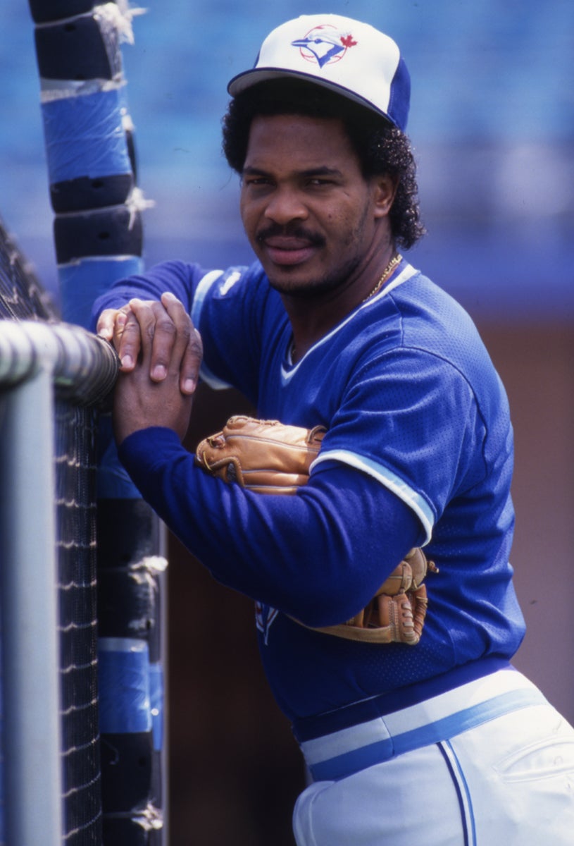 George Bell leans against batting cage