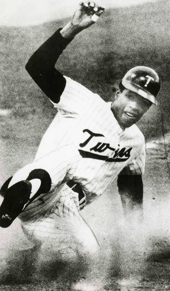 Rod Carew slides into a base