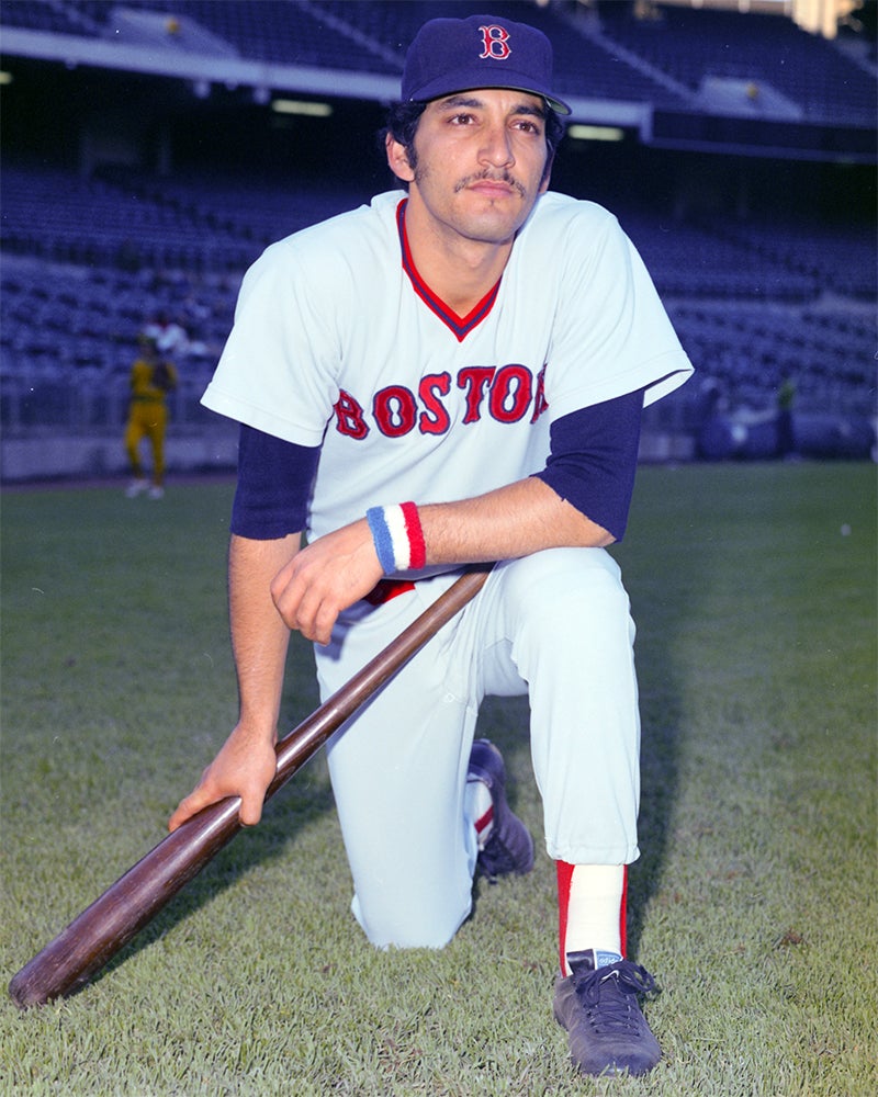 Posed portrait of Mario Guerrero on one knee wearing Red Sox uniform