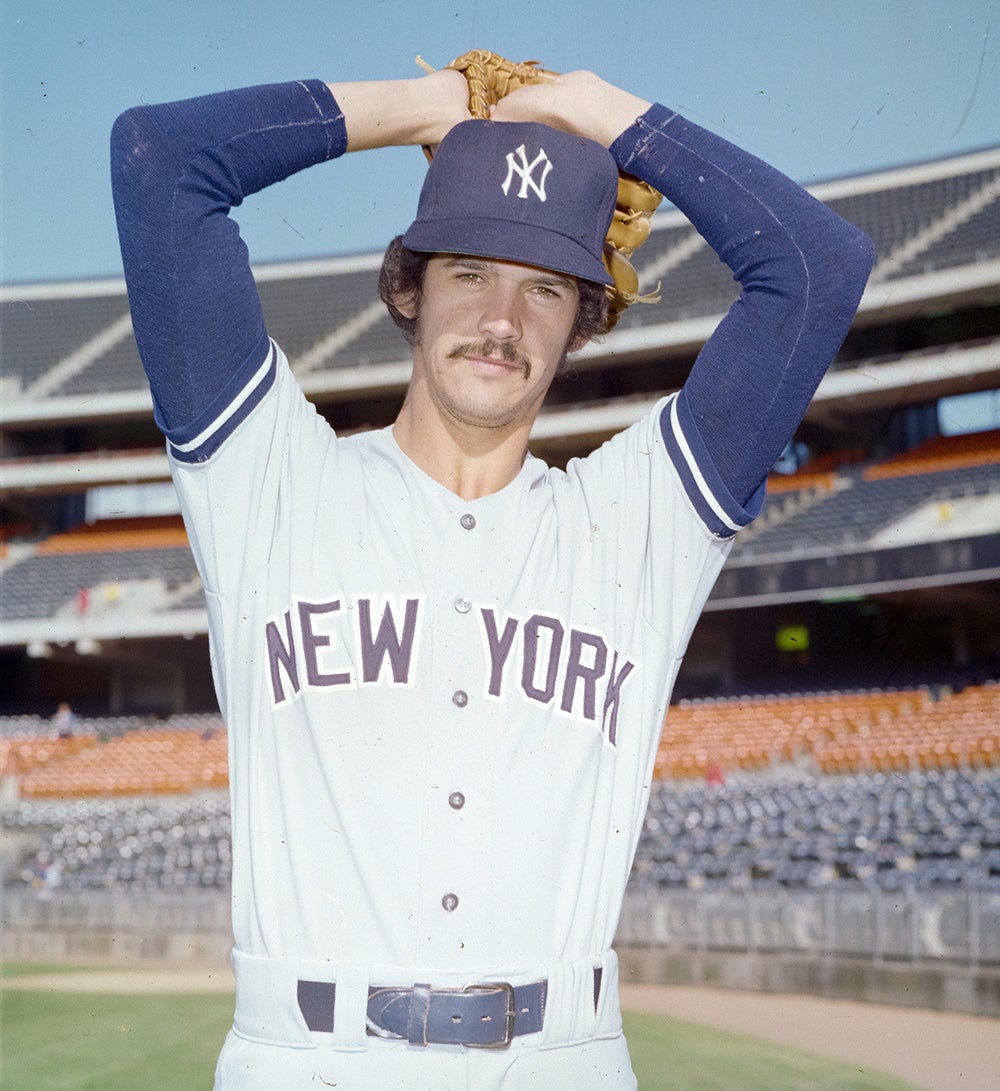 Portrait of Ron Guidry with arms raised