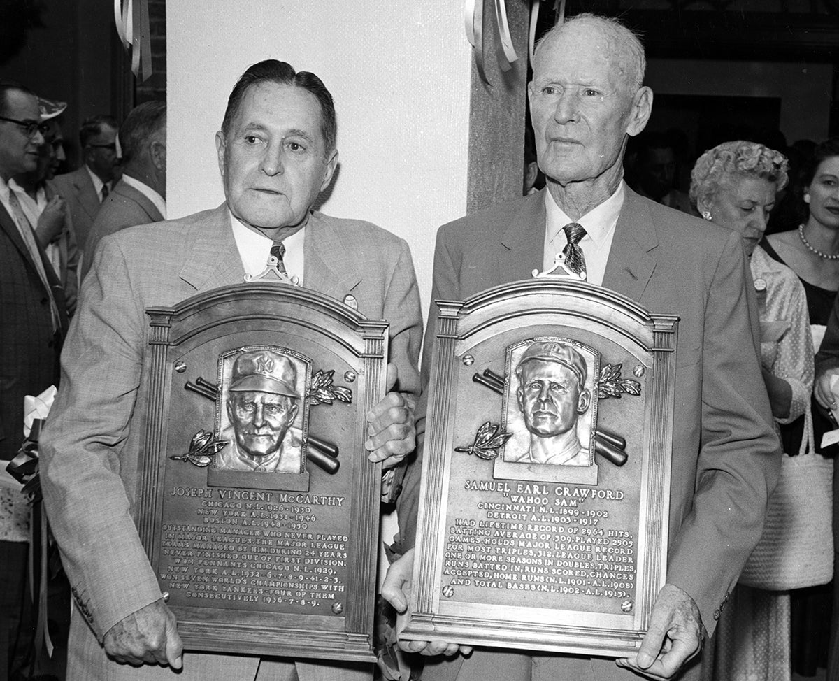 Joe McCarthy and Sam Crawford holding Hall of Fame plaques