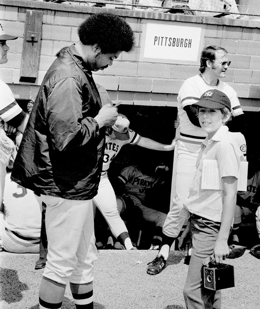 Dock Ellis signs autograph for young fan