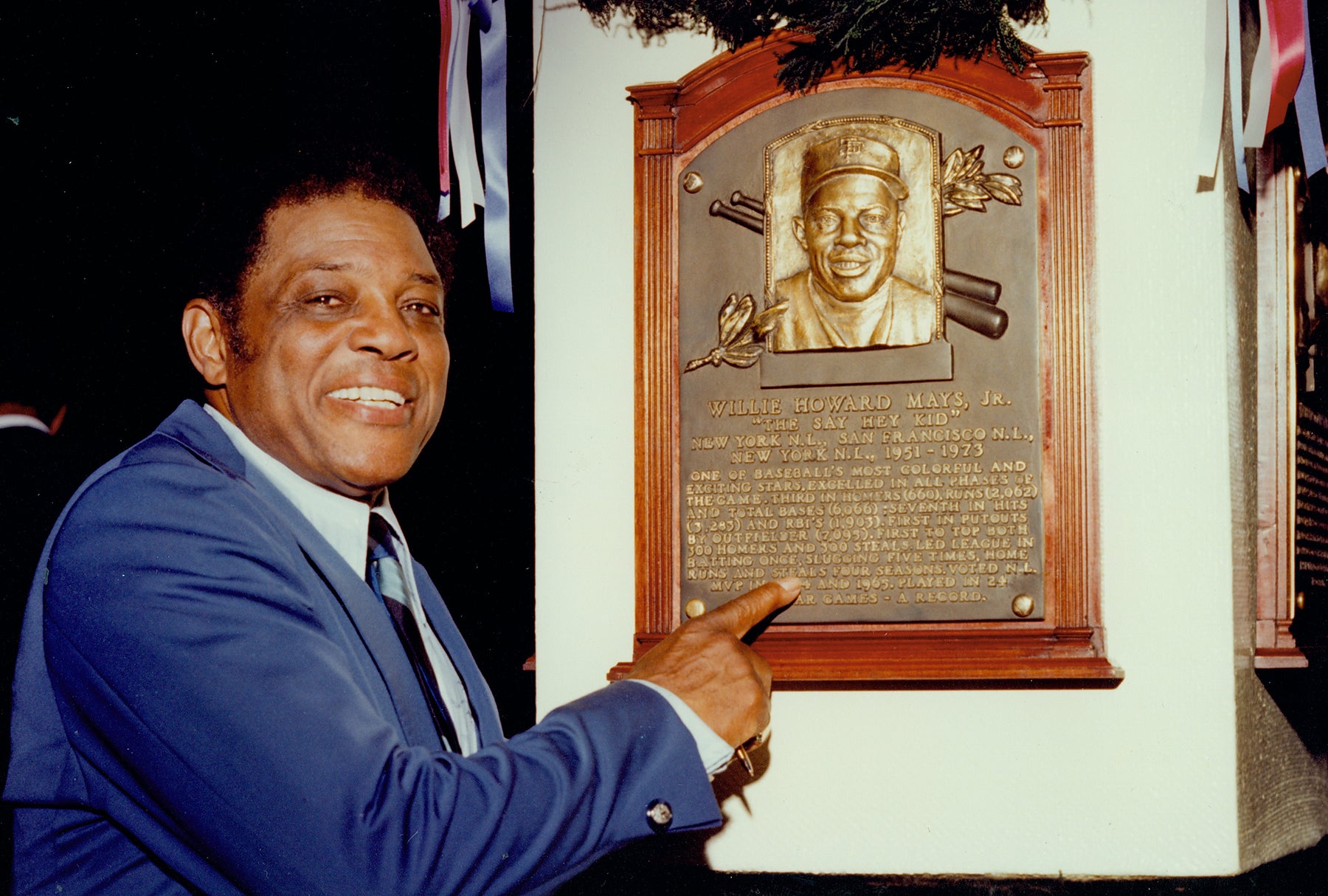 Willie Mays points to his Hall of Fame plaque