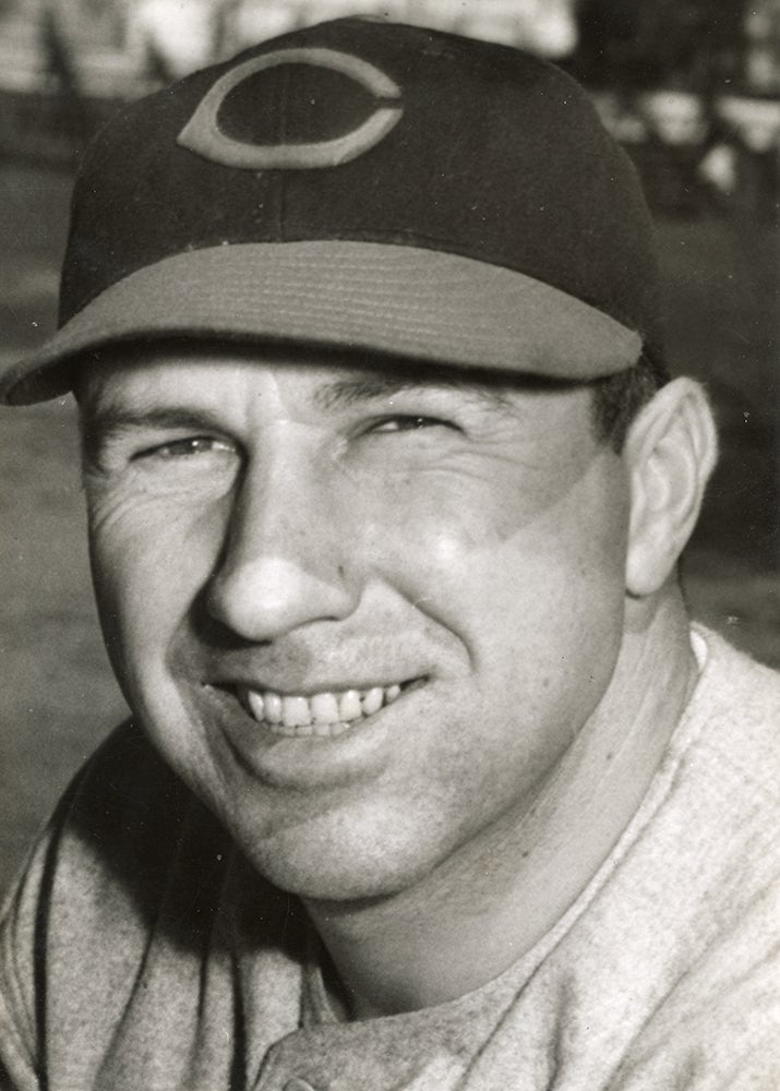 Head and shoulders portrait of Ernie Koy in Reds cap