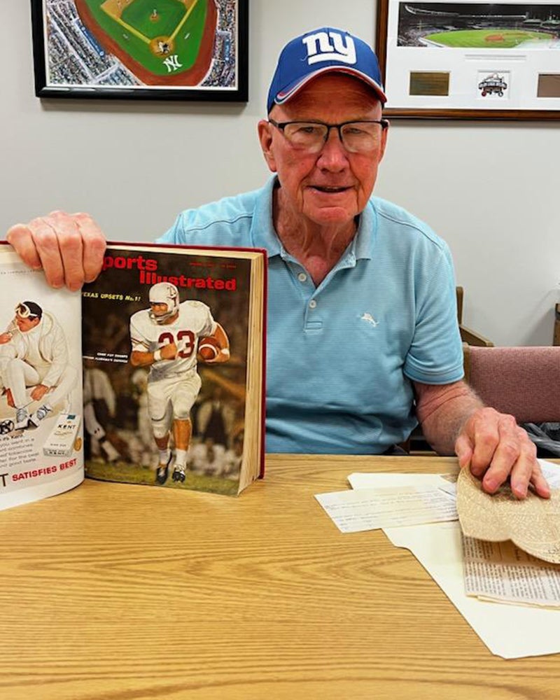 Ernie Koy Jr. with bound book featuring Sports Illustrated cover