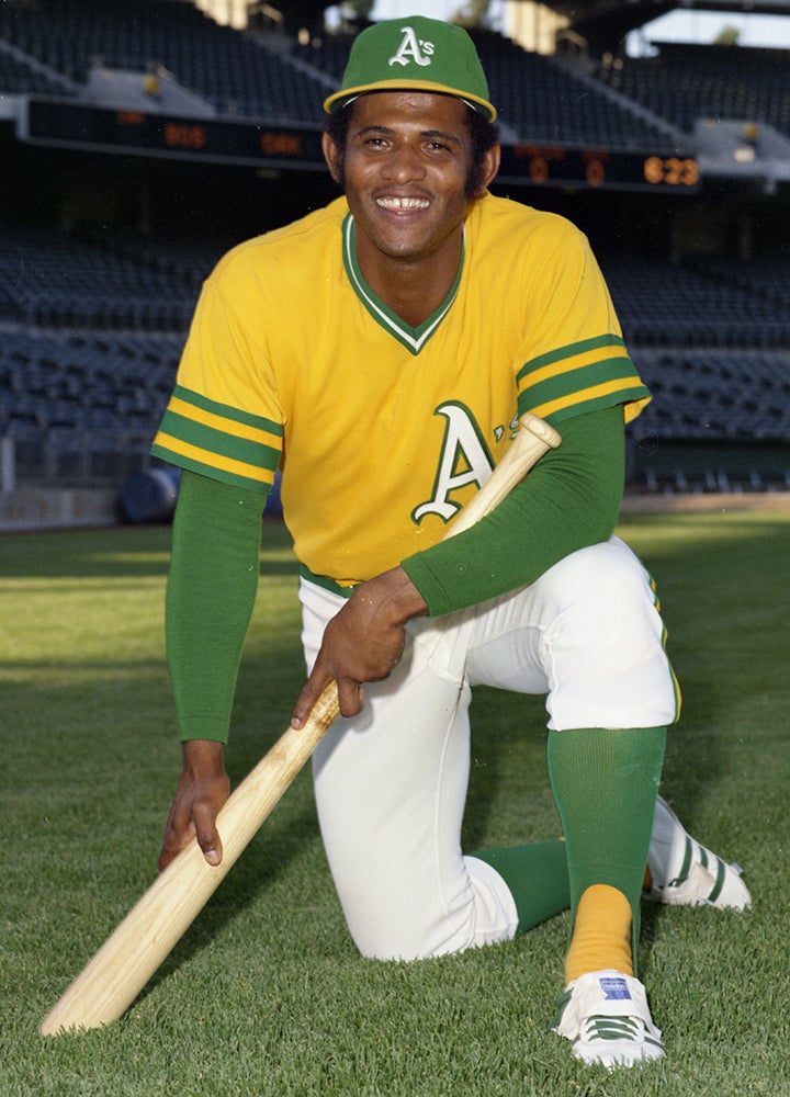 Posed portrait of Ángel Mangual in gold Athletics jersey