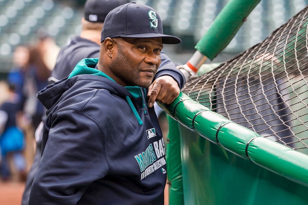 Lloyd McClendon in Mariners sweatshirt behind batting cage