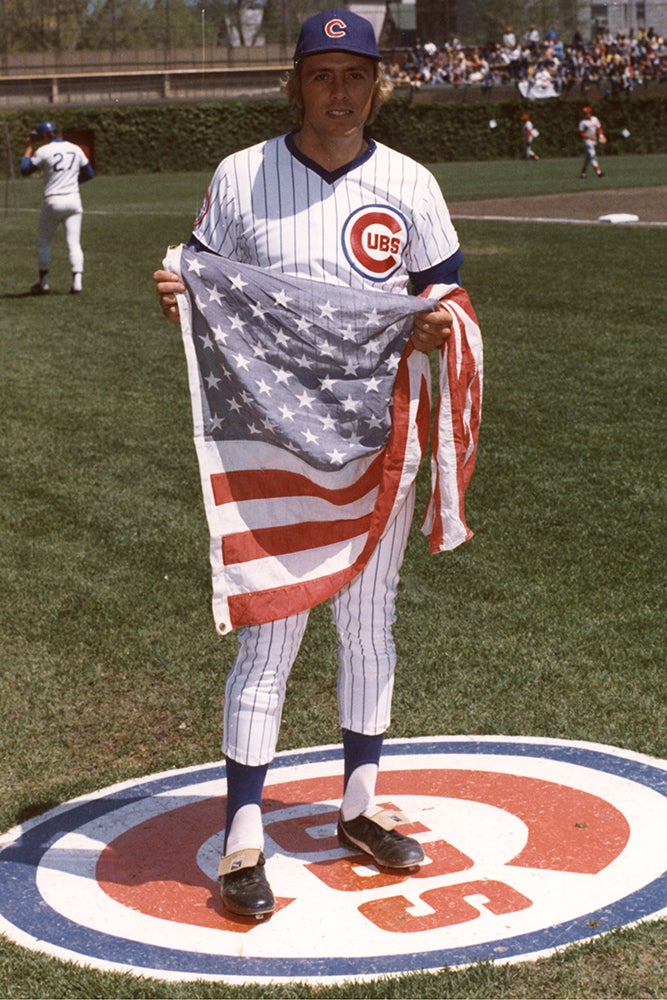 Rick Monday holding United States flag