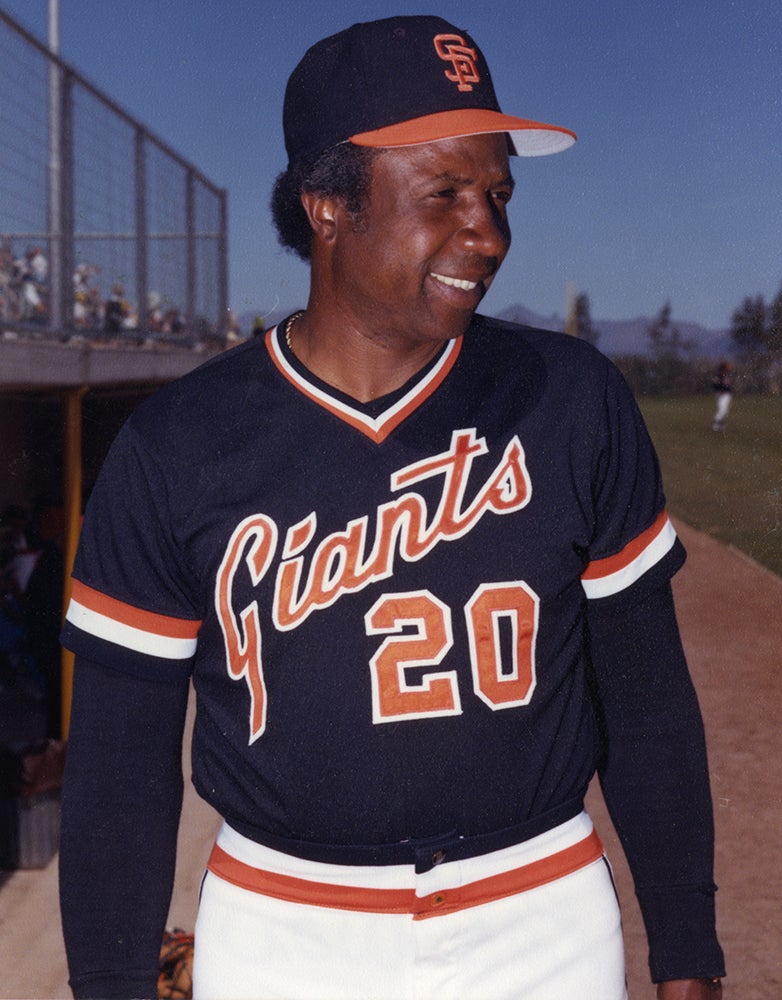 Frank Robinson wearing black Giants jersey