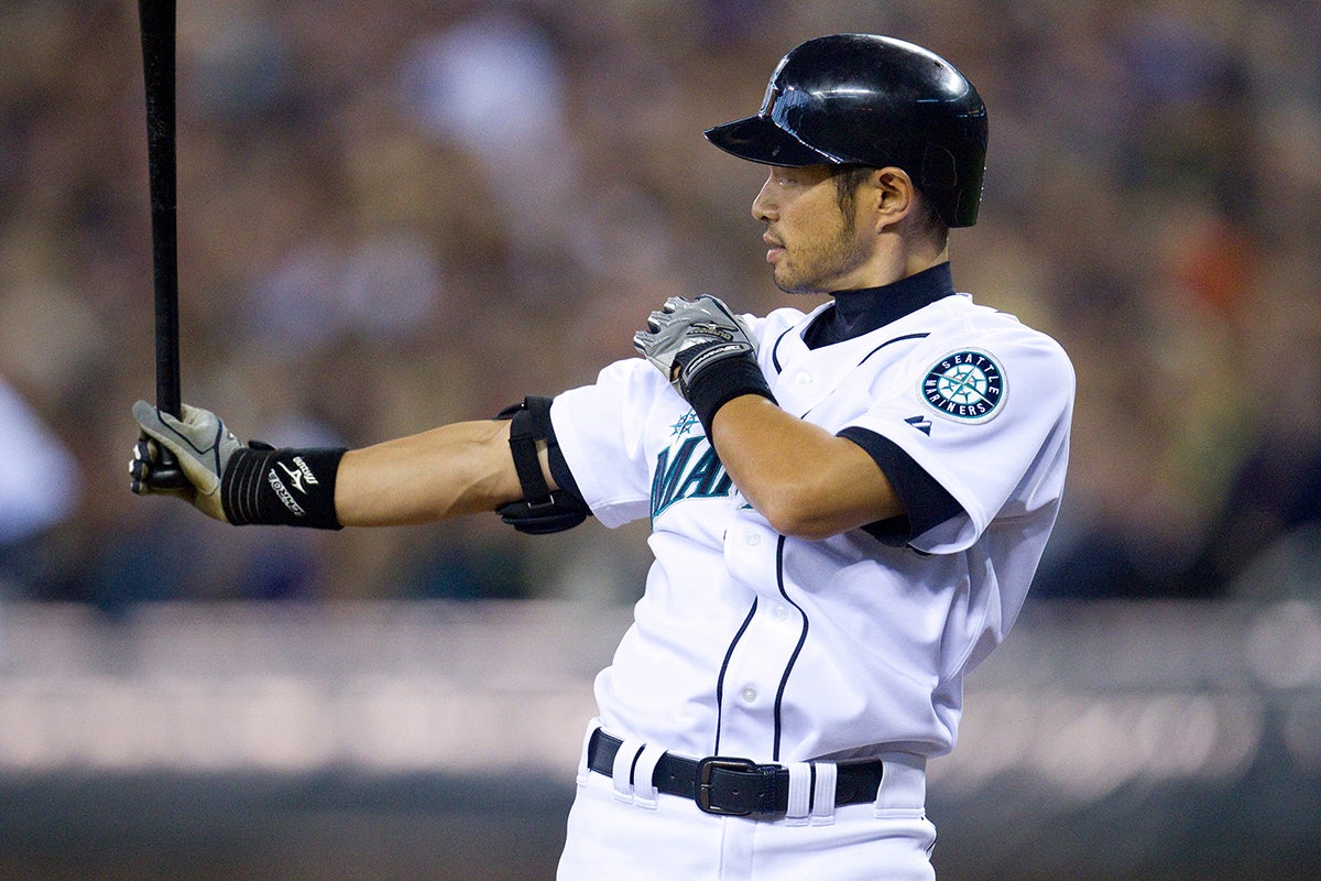 Ichiro extends right arm holding bat