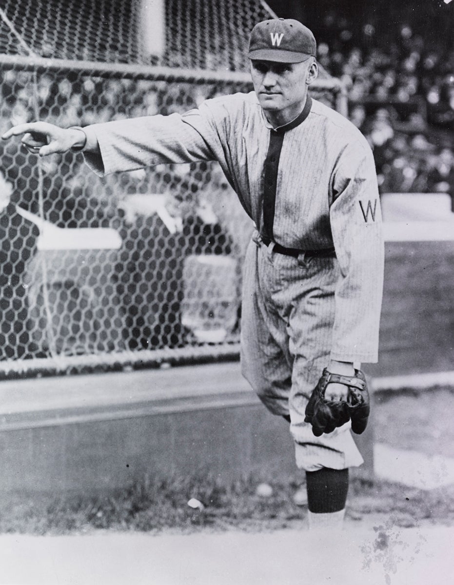 Pitching portrait of Walter Johnson in pinstripe Washington Senators uniform