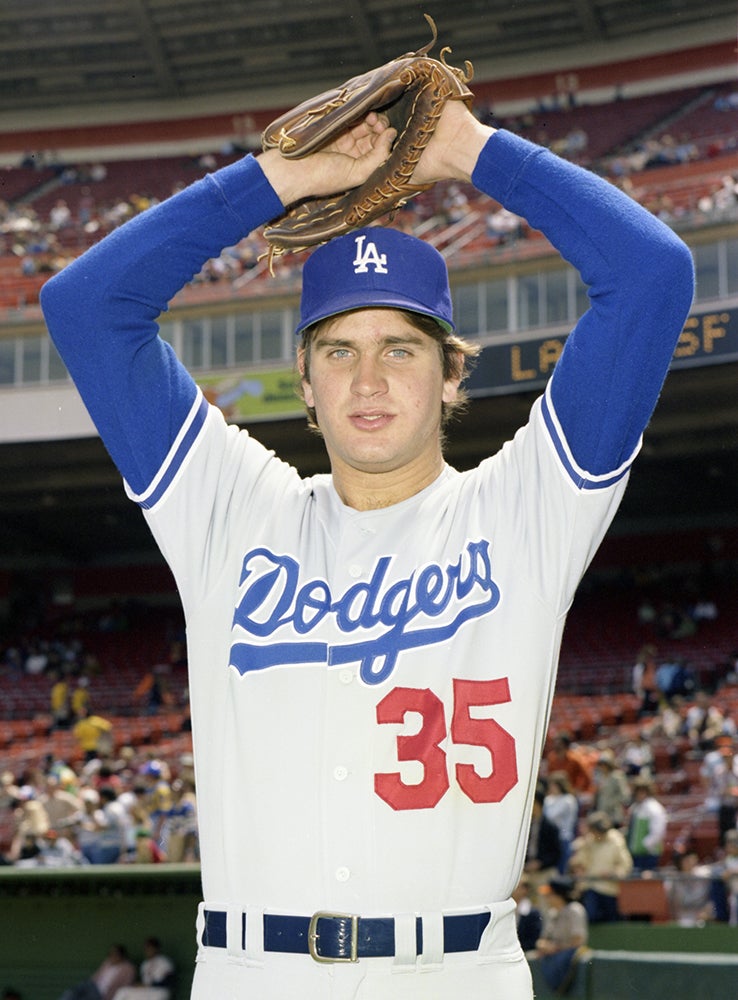 Portrait of Bob Welch in Dodgers uniform with arms raised