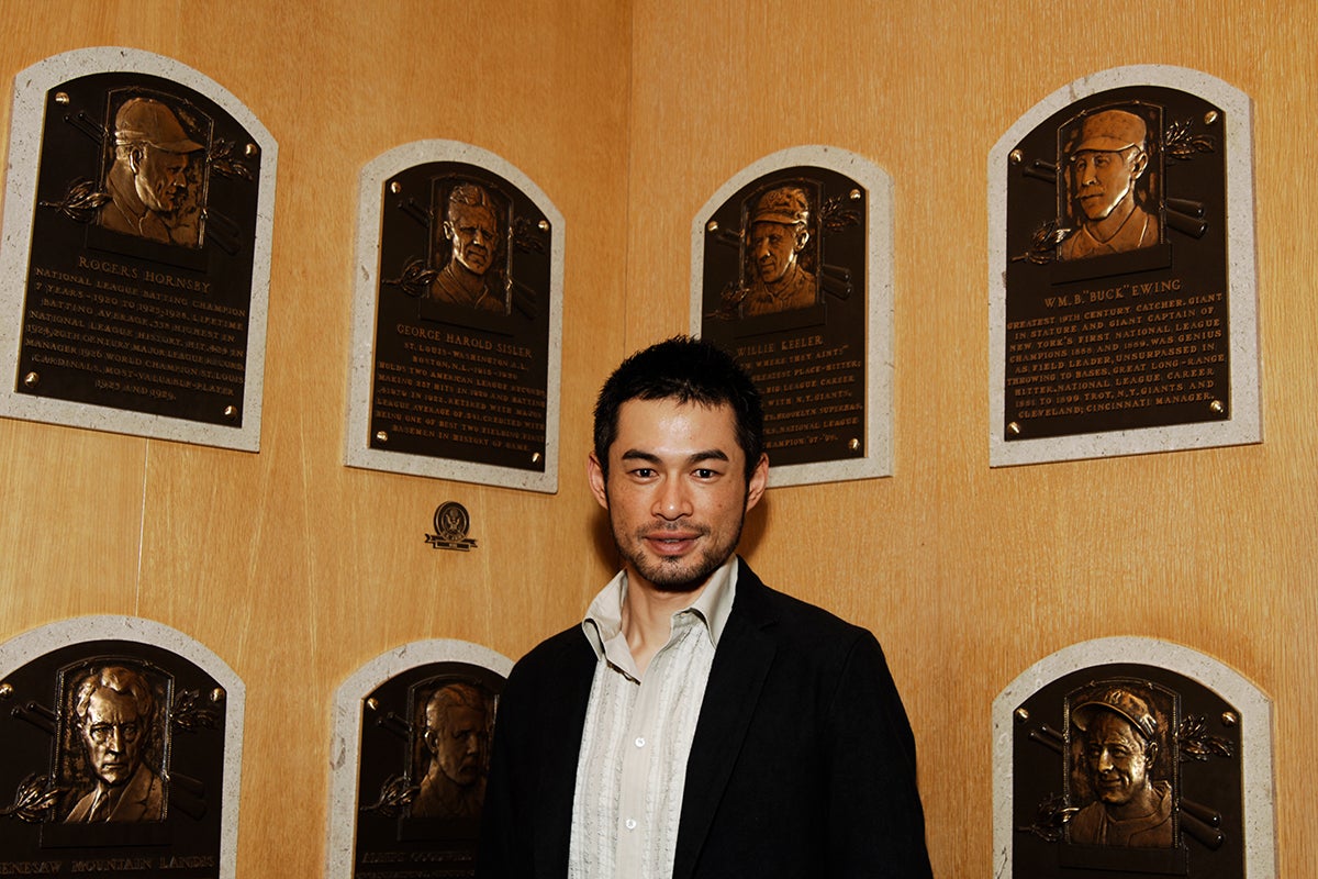 Ichiro Suzuki stands underneath plaques of George Sisler and Willie Keeler