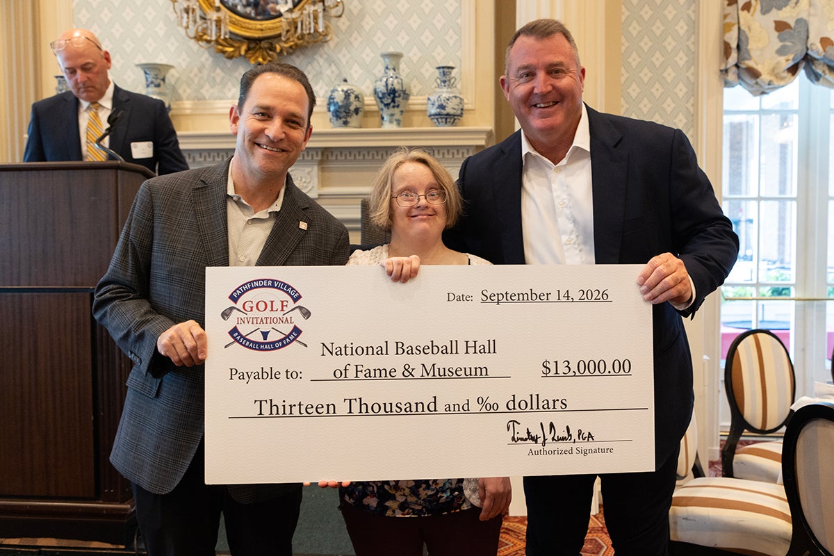 Josh Rawitch, Linda McCord and Jim Thome holding ceremonial check