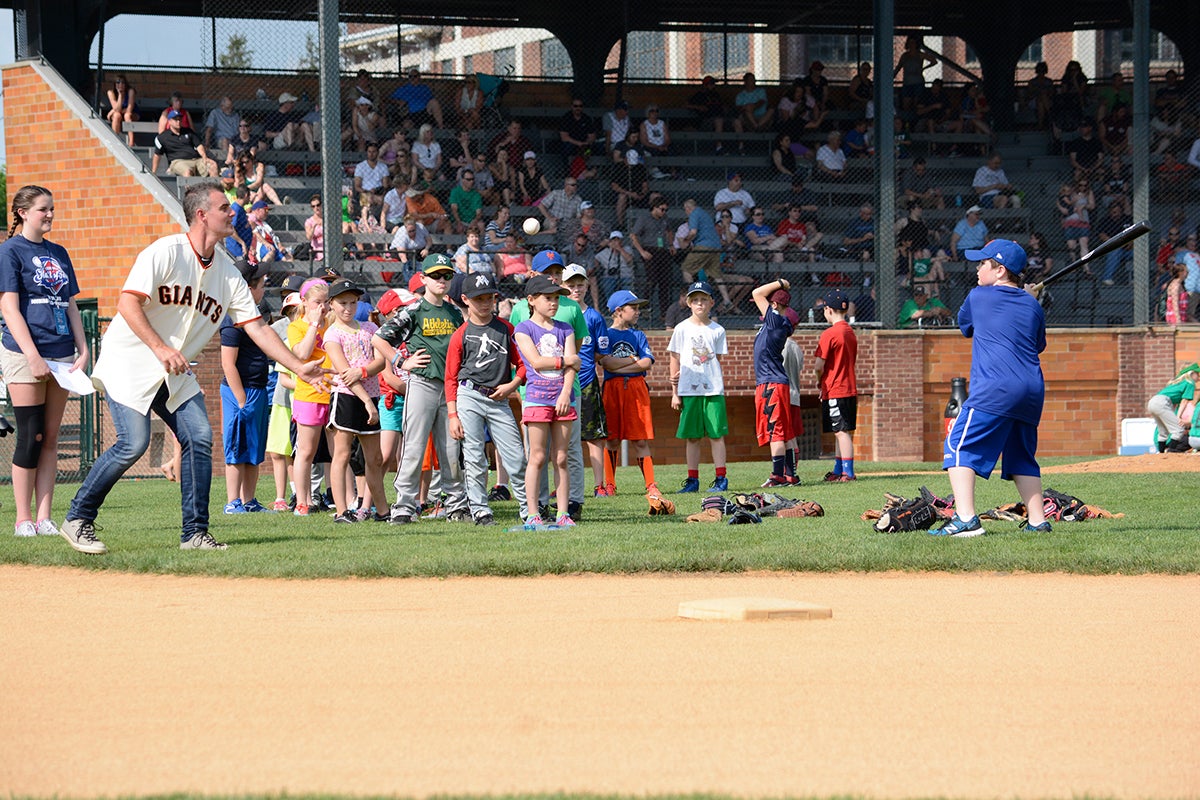 Kids enjoying a baseball clinic on Doubleday Field