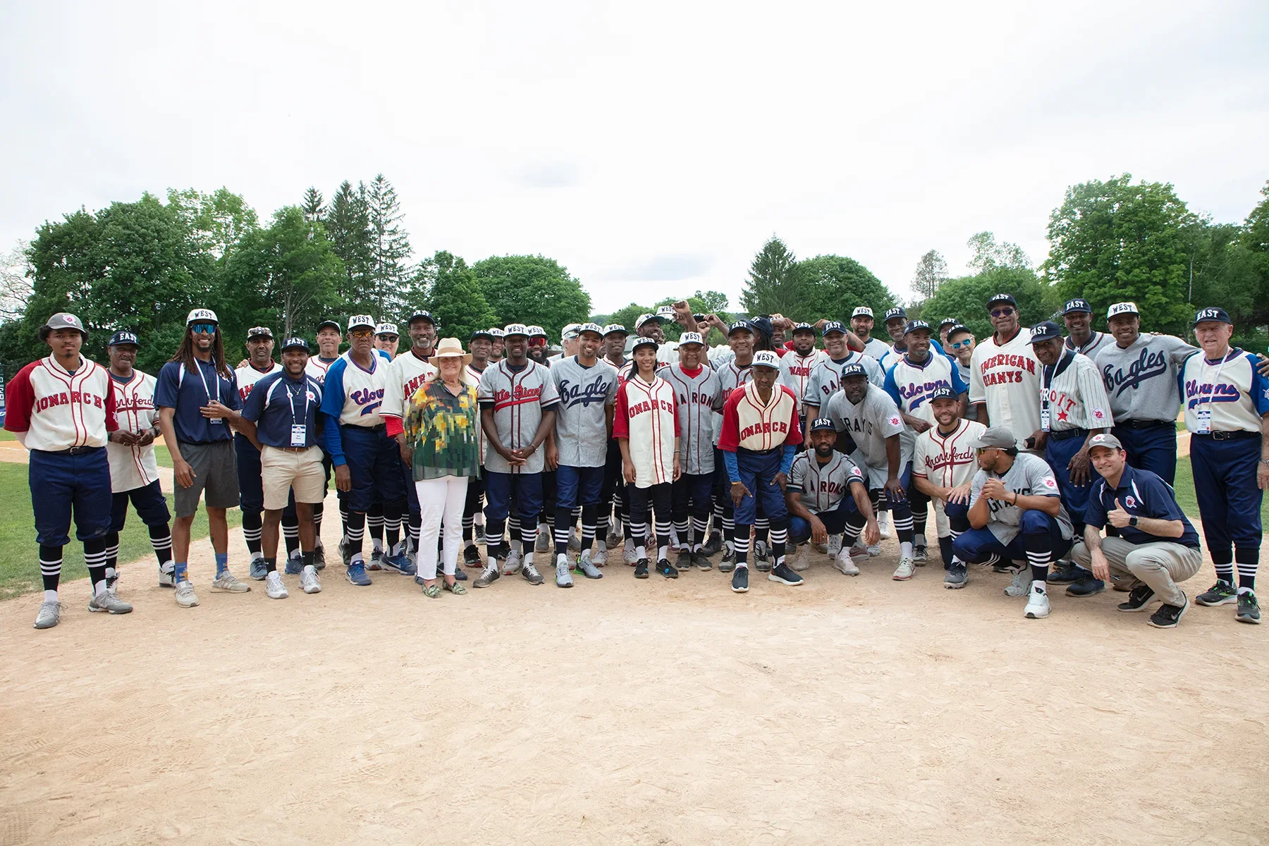 The players, Hall of Famers, Jane Forbes Clarck and Josh Rawitch on Doubleday Field following the Hall of Fame East West Classic game