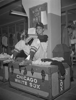 Luis Aparicio sitting on top of a Chicago White Sox trunk. (Osvaldo Salas Collection / National Baseball Hall of Fame Library)