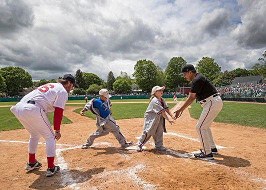 Participants in the race around the bases in-between innings are greeted at home plate by Hall of Famers Juan Marichal and Wade Boggs. (Jean Fruth / National Baseball Hall of Fame and Museum) 