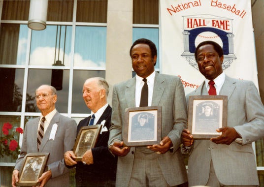 From left, Veterans Committee electees Travis Jackson and Happy Chandler receive their Hall of Fame plaques with BBWAA electees Frank Robinson and Hank Aaron during the Hall of Fame Induction Ceremony on Aug. 1, 1982 in Cooperstown, N.Y. BL-4982-84 (National Baseball Hall of Fame Library)