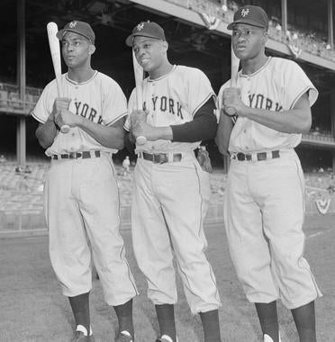 From left, Monte Irvin, Willie Mays and Hank Thompson of the Giants pose for a photo at Yankee Stadium. (Osvaldo Salas/National Baseball Hall of Fame and Museum)
