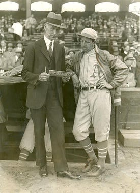 Philadelphia Athletics' manager Connie Mack (left) converses with fellow Hall of Famer Eddie Collins outside the team's dugout. (National Baseball Hall of Fame and Museum)  