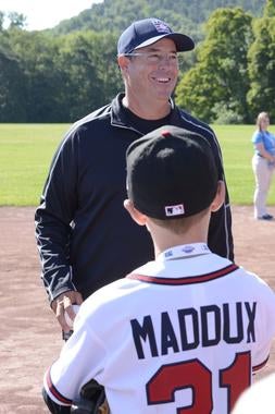 Hall of Fame pitcher Greg Maddux enjoys a laugh with a young fan during the 14th annual PLAY Ball fundraiser Friday morning at the Clark Sports Center in Cooperstown. (Milo Stewart, Jr. / National Baseball Hall of Fame)