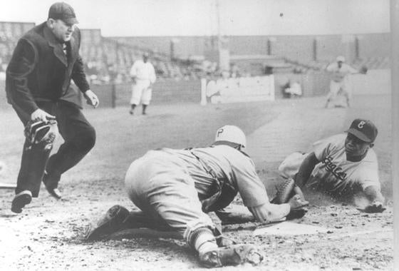 Larry Doby slides home as a member of the Newark Eagles during a Negro Leagues game against the Philadelphia Stars in 1946. (Larry Hogan Collection / National Baseball Hall of Fame and Museum) 