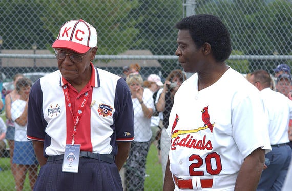 Buck O'Neil, left, and Lou Brock share a moment in Cooperstown during Hall of Fame Weekend on July 27, 2004. (Milo Stewart Jr./National Baseball Hall of Fame and Museum)