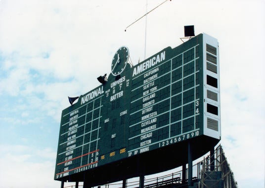 Some of the wholly unique aspects of “The Friendly Confines” include the old-fashioned scoreboard in center field, the proximity of fans to the field and the ivy-lined outfield walls that have given opposing players fits for decades. (National Baseball Hall of Fame Library)